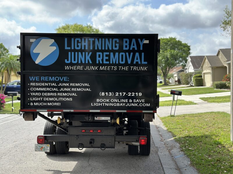 Lightning Bay Junk Truck on Sidewalk with Grass